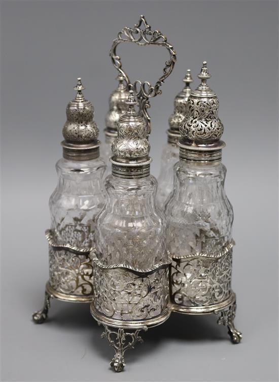 A George III silver cruet stand, William Plummer, London, 1775, with five bottles with unmarked covers, 29cm.